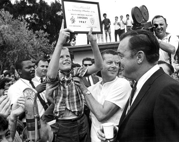 Billy Churchill holding up certificate while Governor Kirk watches – Satellite Beach,